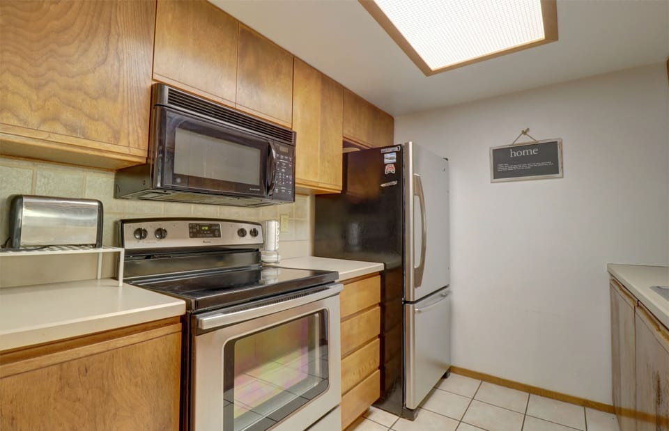 Kitchen features stainless steel appliances.