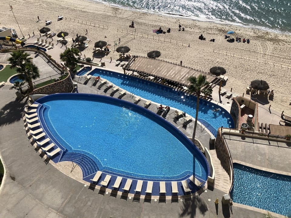 Large infinity pool with children's play pool and heated swim up bar pool