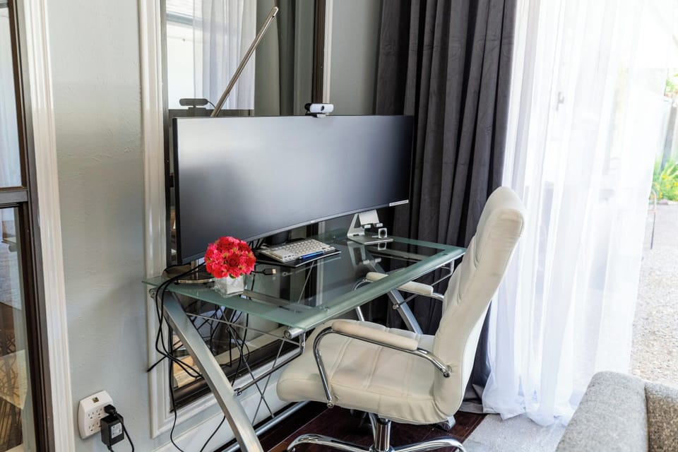 We provide a giant 49" curved monitor, a printer, webcam, and a dedicated office desk for those times when you have to mix work and play. 