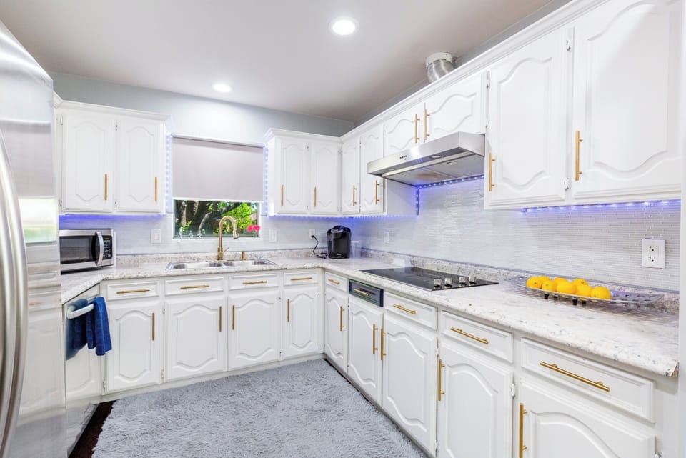 Kitchen features stainless steel appliances, dishwasher, microwave, coffee pot, blender, toaster, etc.