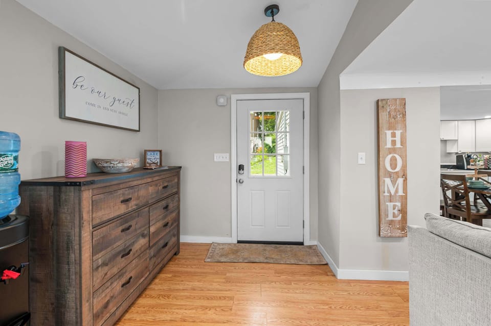 A warm and welcoming entry into Little Landing Cottage, with an open layout that leads directly into the living and dining areas.