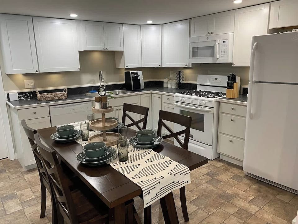 Imagine preparing your favorite meal in this fully equipped kitchen, with everything you need right at your fingertips. A cozy dining area awaits, perfect for enjoying a delicious meal and great conversation