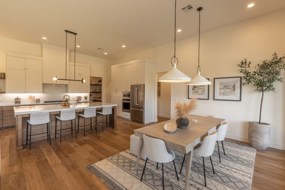 Dining Table and Kitchen - With an open and spacious floor plan, the Dining Room and Kitchen can accommodate meal preparations for groups large or small.
