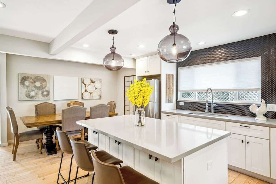 Bright and modern kitchen with a spacious island, stylish lighting, and plenty of room to cook, gather, and enjoy meals together.
