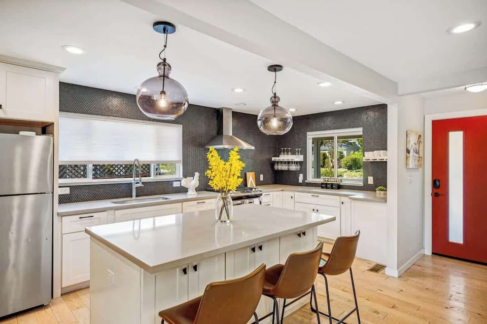 A stylish, light-filled kitchen with a roomy island and warm touches—perfect for cooking, gathering, and enjoying time together.
