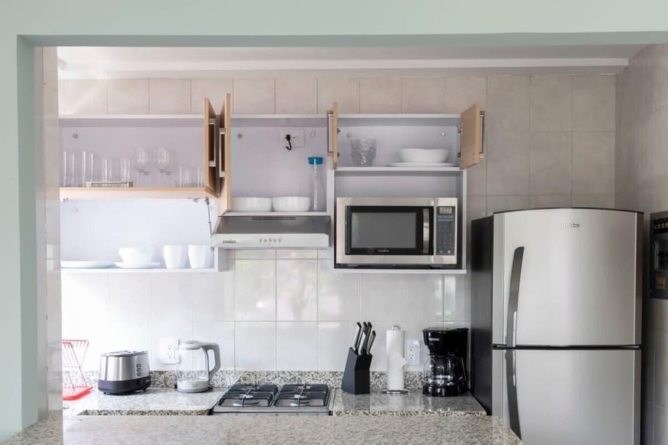 Fully equipped kitchen with appliances and utensils