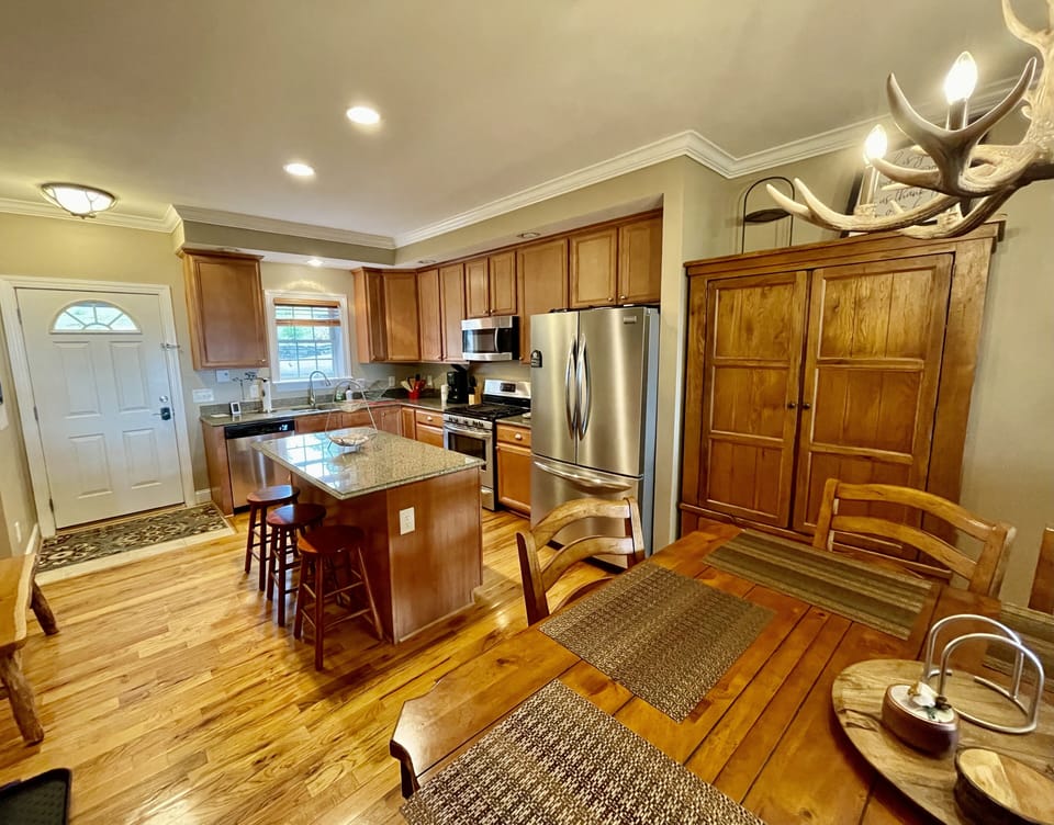 Updated kitchen with stainless steel appliances, gas stove and plenty of dishes.