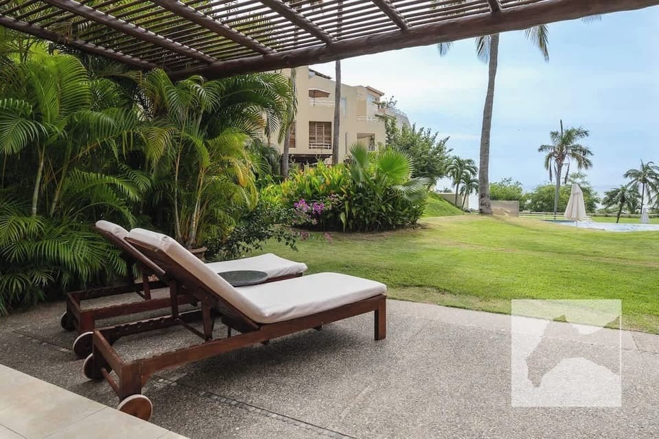 Private beachfront patio with lounge chairs 