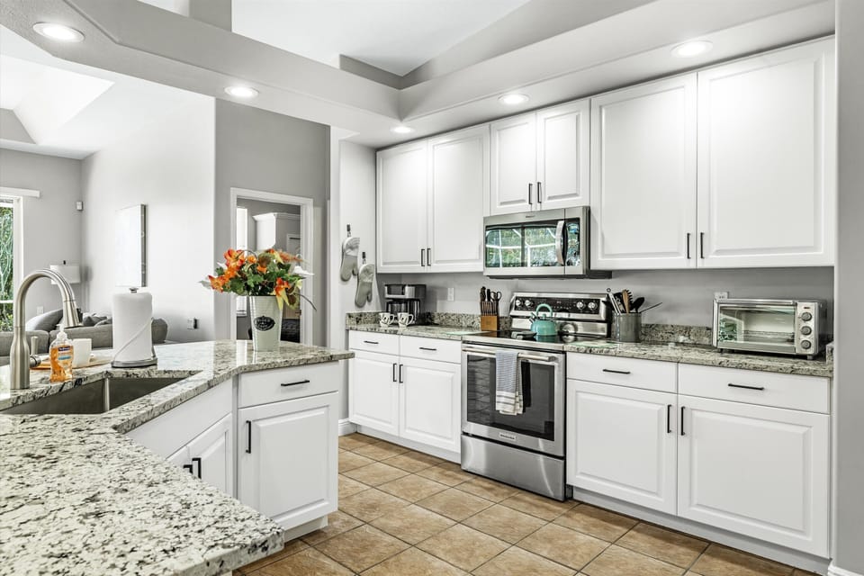 The fully-equipped kitchen with stainless steel appliances