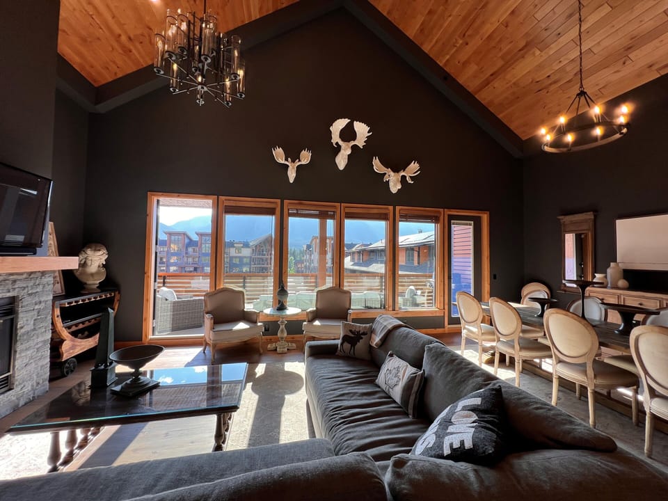Sunny living room with vaulted ceilings and incredible mountain views