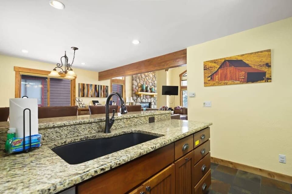 The open layout of this home means you can stay connected with your loved ones in the living and dining areas even as you grab a snack or whip up a meal in the kitchen, which boasts stainless steel appliances and granite countertops.