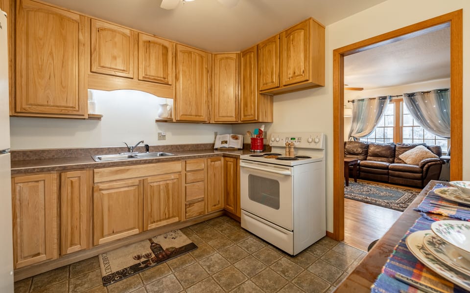 Bright and welcoming kitchen now with a full size washer and dryer for your convenience.
