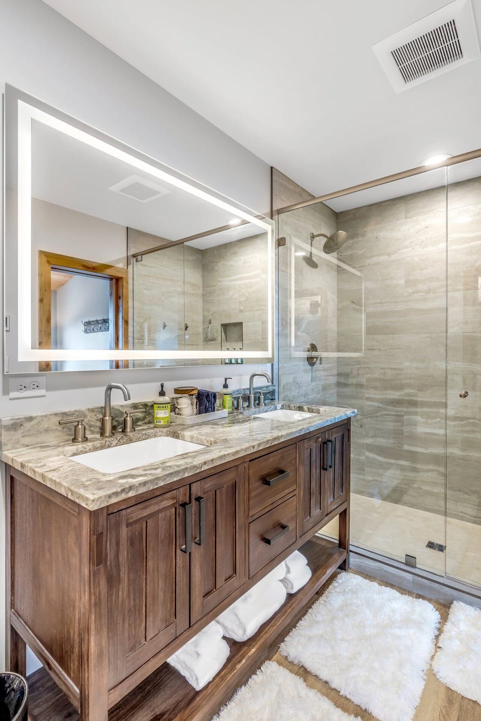 Master ensuite bathroom with luxury walk-in shower, high end electric mirrors, double vanity, toilet and walk-in closet.