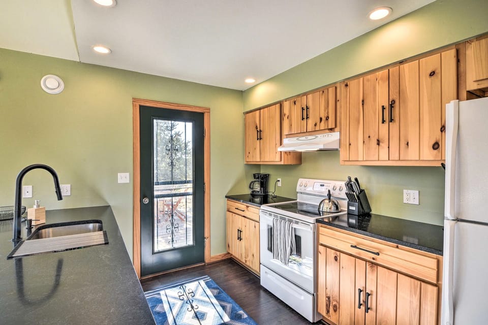 Galley kitchen with access to the back deck for morning coffee outdoors.