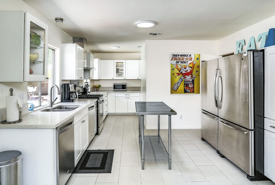Fully equipped kitchen with 2 stainless fridges and prep island
