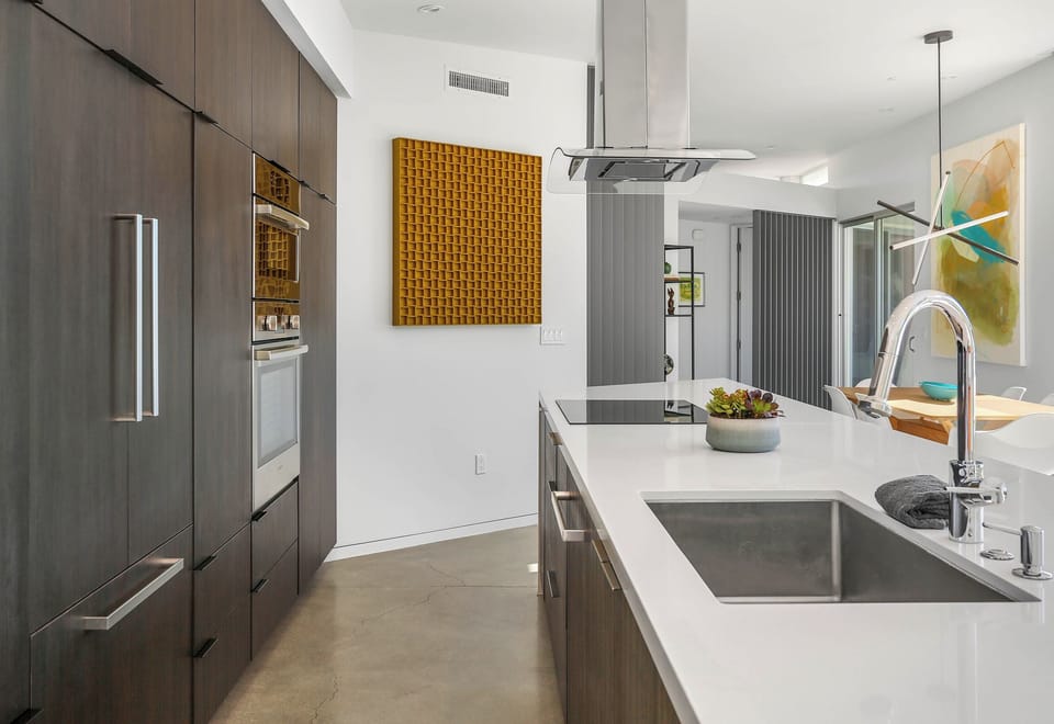 Sleek modern kitchen with built-in appliances and waterfall island