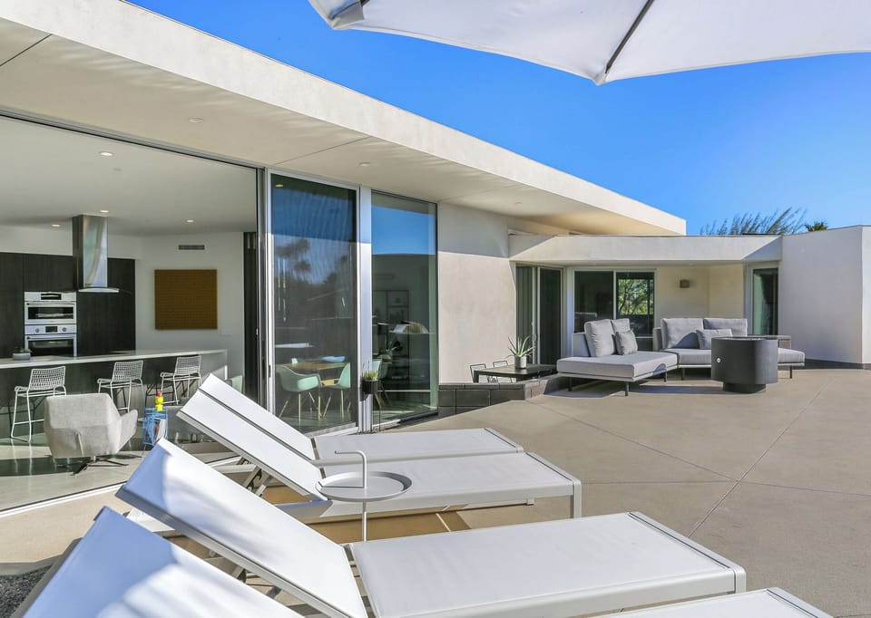 Spacious pool deck with loungers and seamless indoor-outdoor design