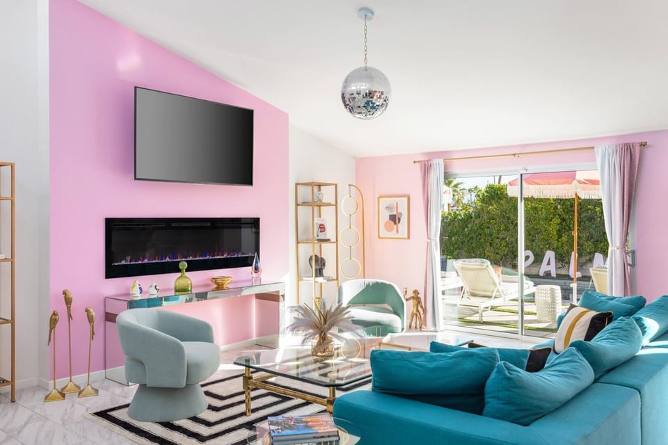 Bright living area with fireplace, modern seating, and backyard access