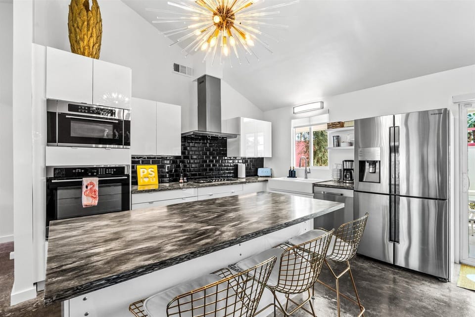 Chef's kitchen with oversized island, bar seating, and stainless appliances