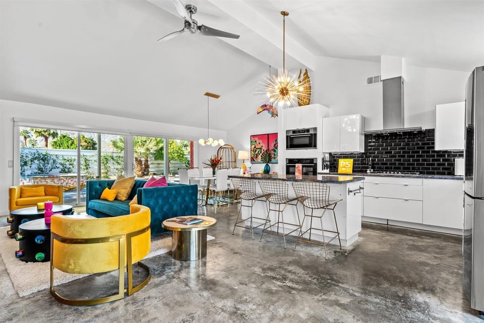 Open-concept living, kitchen, and dining with bold design and natural light
