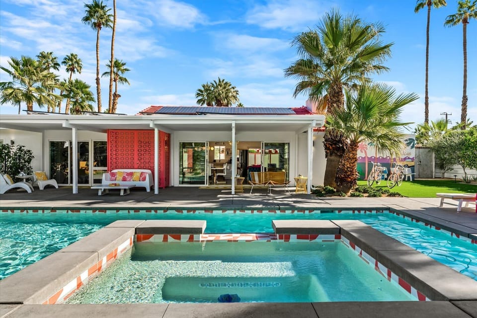 Resort-style backyard with pool, spa, lounge seating, and indoor-outdoor flow