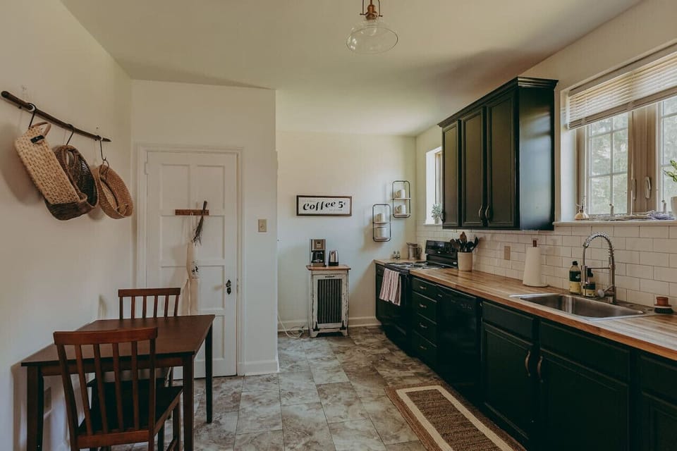 Whole picture of the kitchen with a two-chair table, and ample natural light