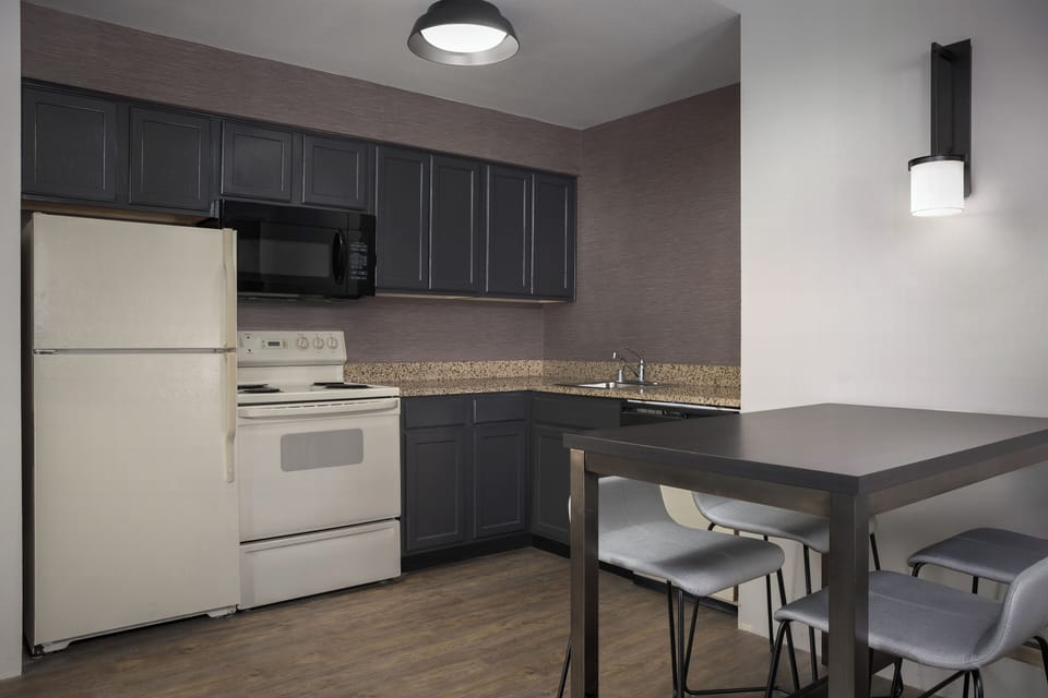Suite, 2 Bedrooms | Private kitchen | Fridge, microwave, stovetop, dishwasher