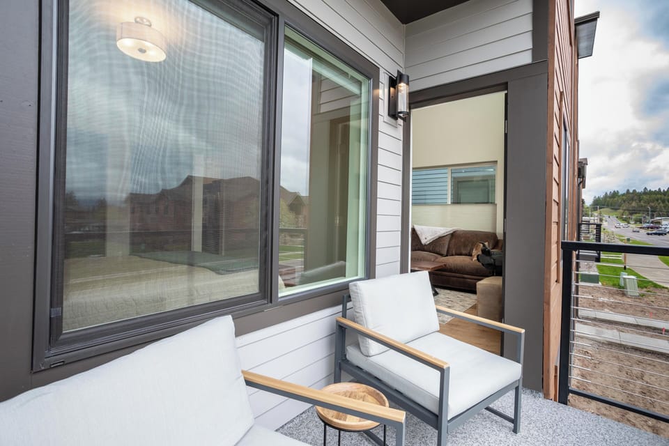 The private balcony is accessible from the living room | Main Level