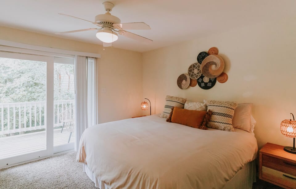 Primary Bedroom with attached full bathroom, Smart TV, and balcony with seating