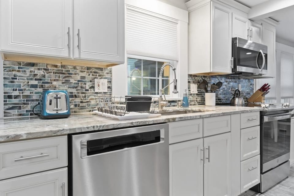 Newly installed kitchen with granite, pull out shelving and dishwasher