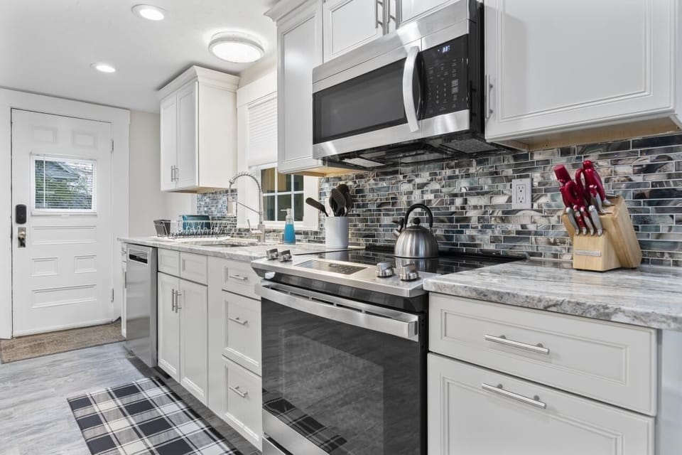 Newly installed kitchen with appliances and backsplash 