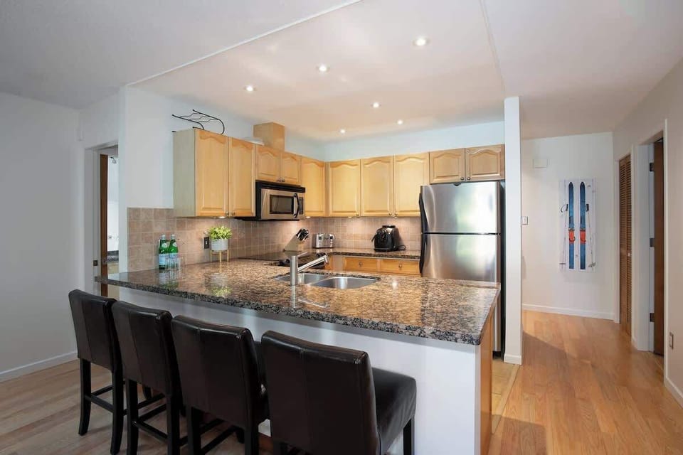 - Spacious kitchen with bar seating for casual morning meals  
- Stainless appliances and granite counters elevate cooking  
- Bright and open layout ideal for group stays or families  
