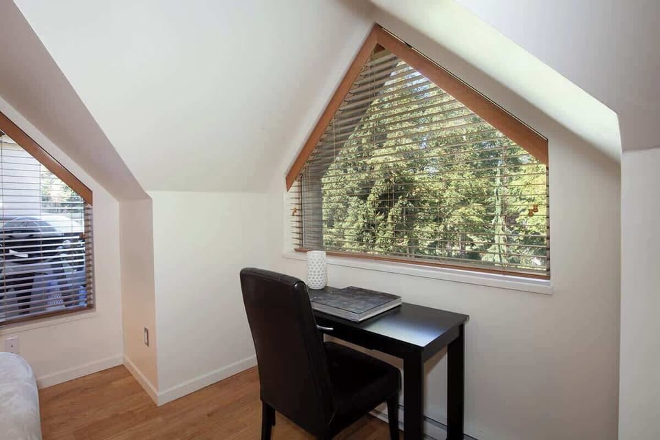 - Cozy workspace with desk and forest views through bright windows  
- Peaceful nook ideal for reading or working remotely  
- Natural light inspires focus and calm during your mountain stay  