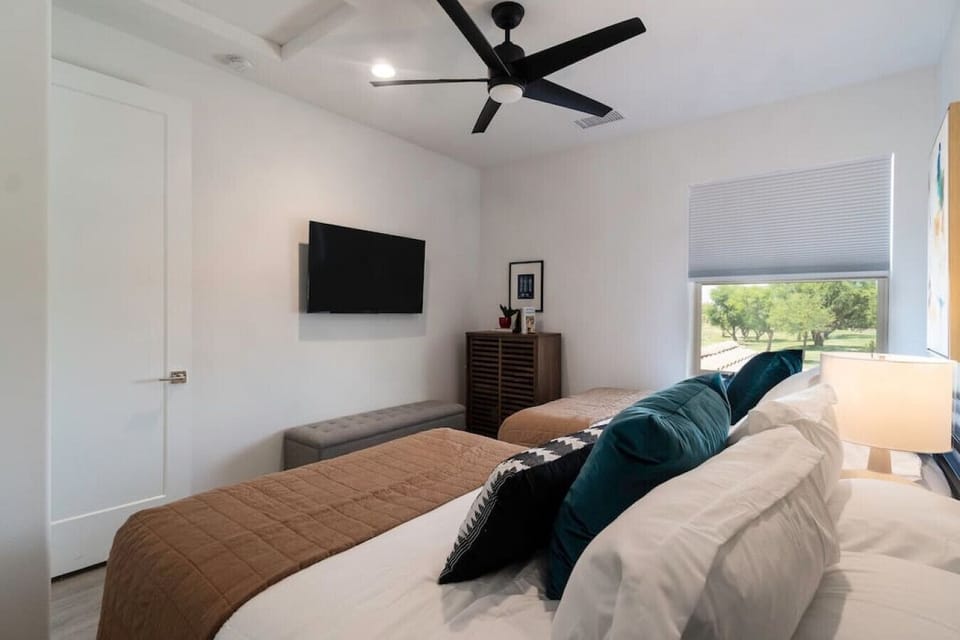 Serene bedroom w/ bed, TV & ceiling fan for a cool, comfortable night
