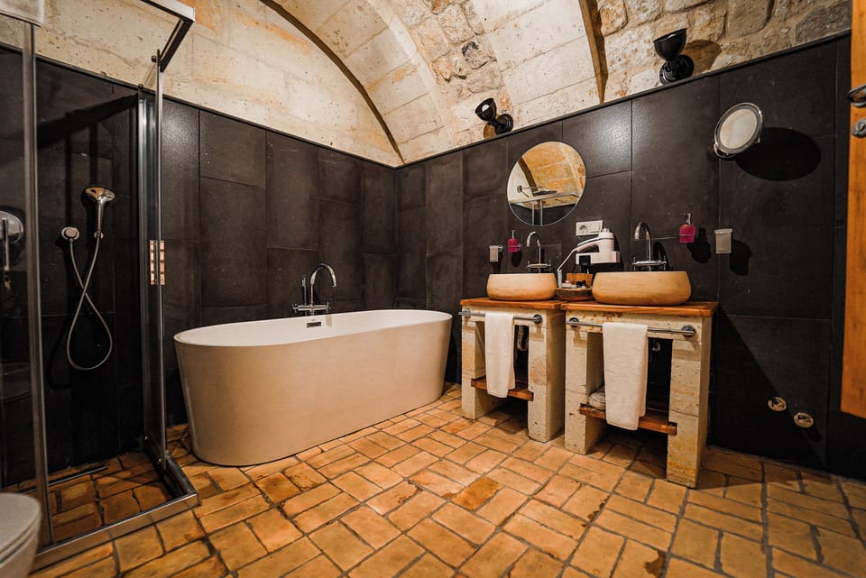 Separate tub and shower, rainfall showerhead, designer toiletries