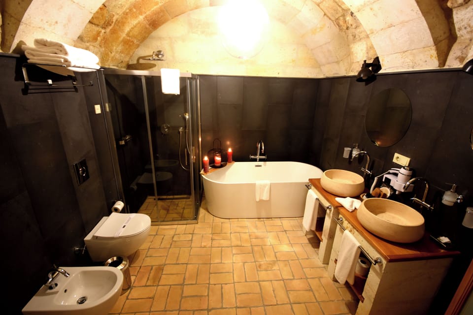 King Cave Suite | Bathroom | Separate tub and shower, rainfall showerhead, designer toiletries