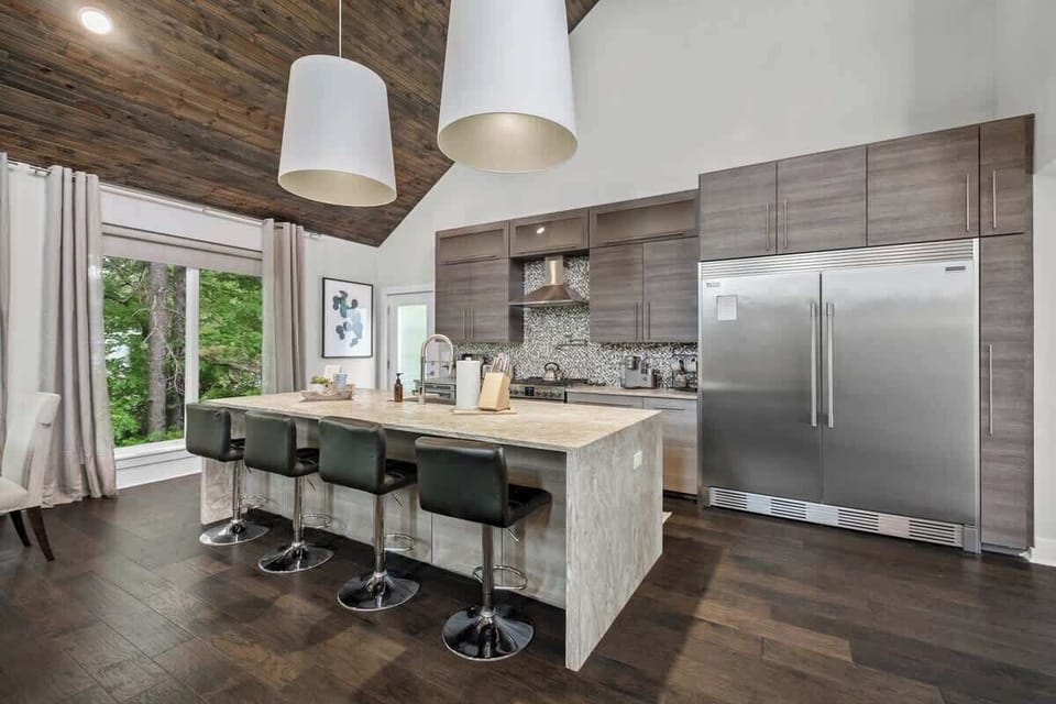 This space is complete with a HUGE granite island, four plush barstools, luxury appliances and tons of built-in storage.