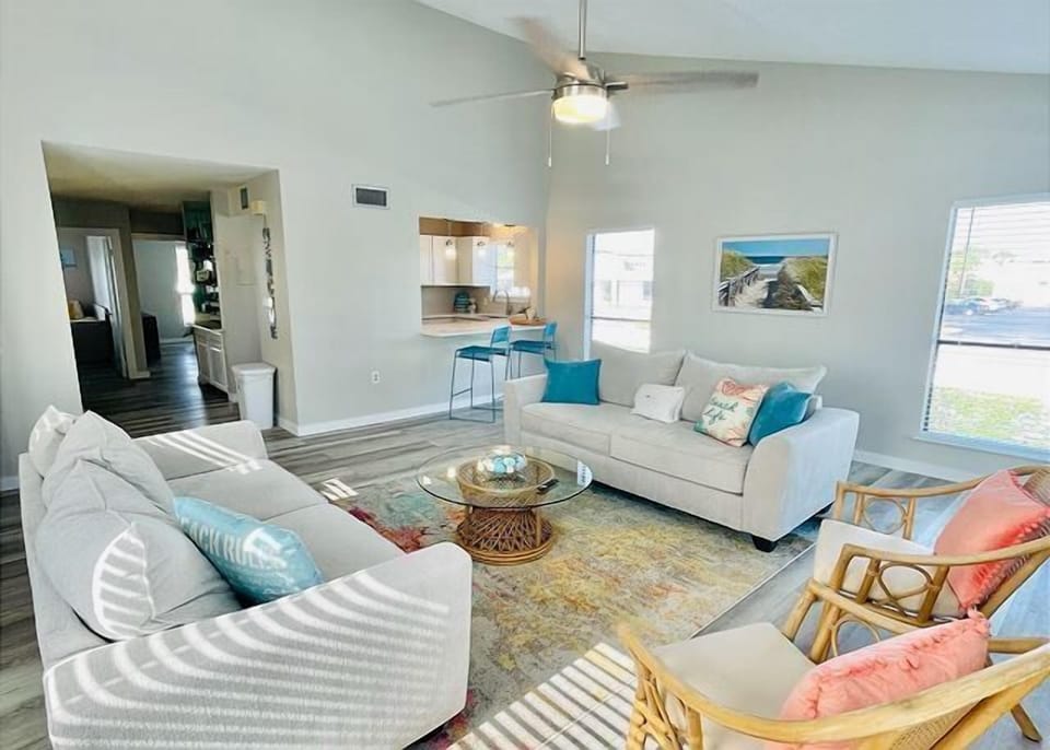 Relax in your spacious living room with plush seating, coastal accents, and an open layout perfect for unwinding after beach days.