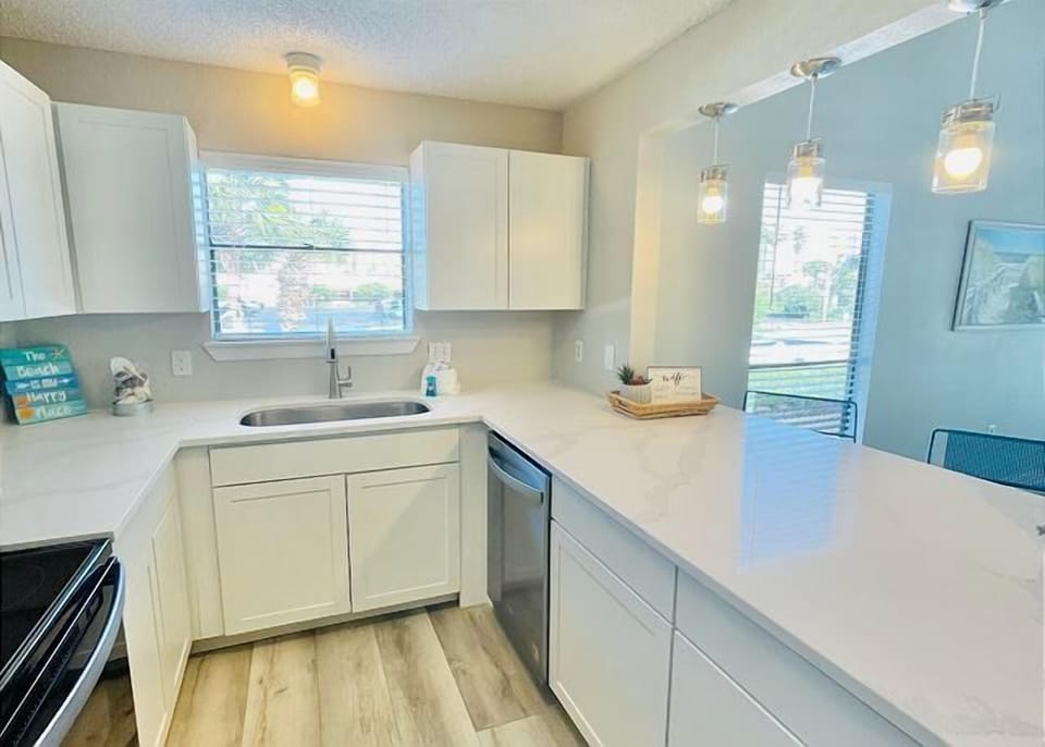 Your bright, modern kitchen features sleek white cabinets, spacious countertops, and everything you need to whip up delicious meals during your stay.
