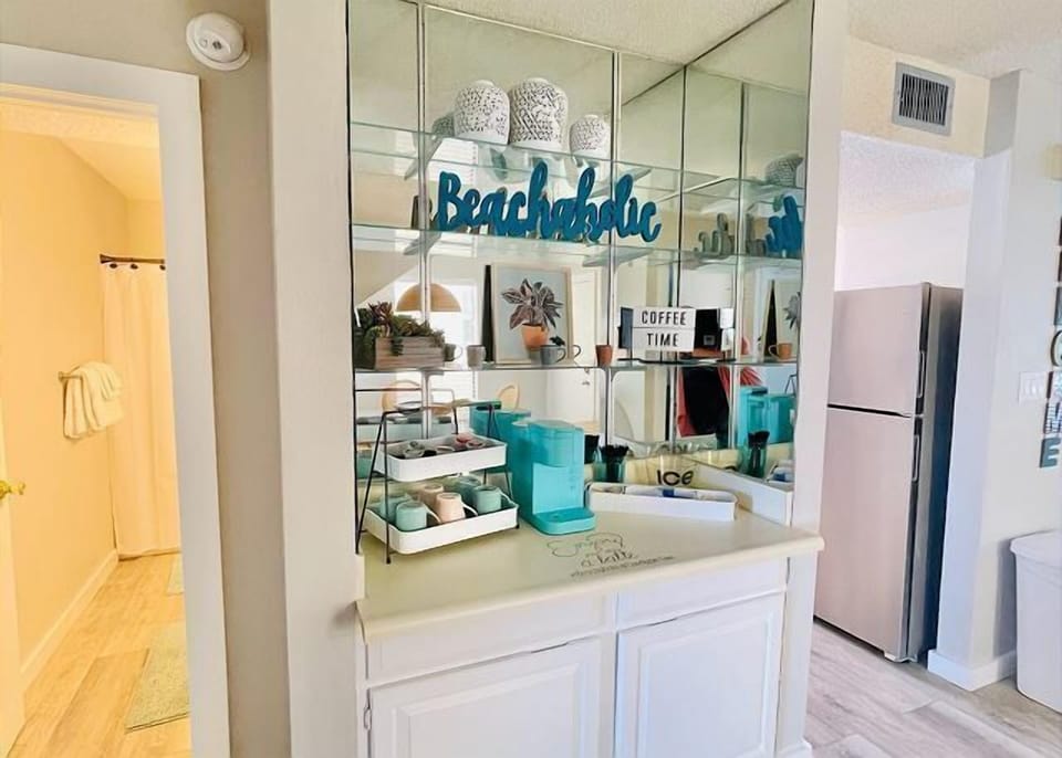 Brew your morning coffee at this stylish beachside beverage station, complete with modern appliances and coastal charm for your daily rituals.