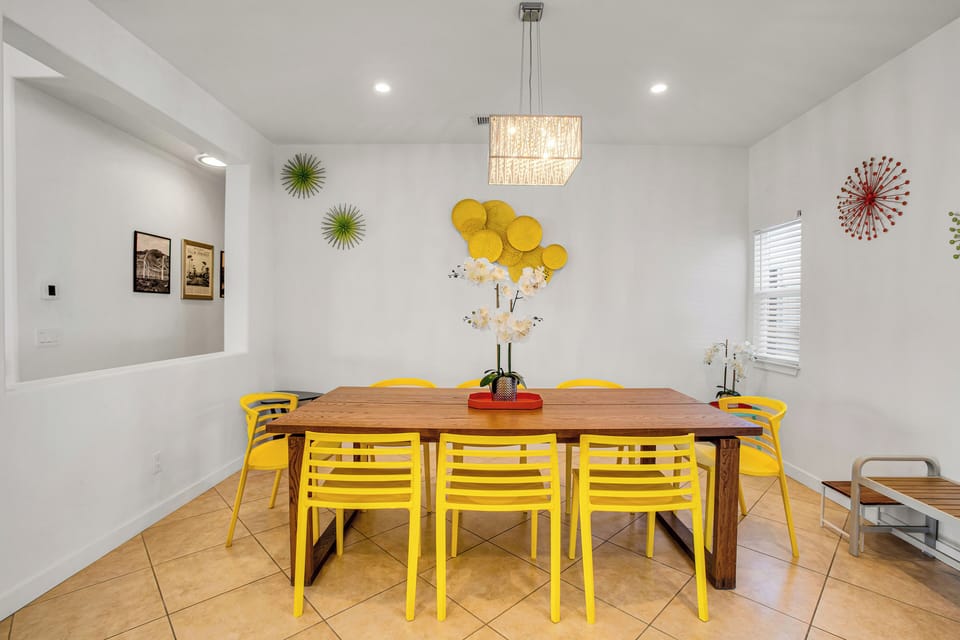 Generous dining table with bright seating and playful desert style