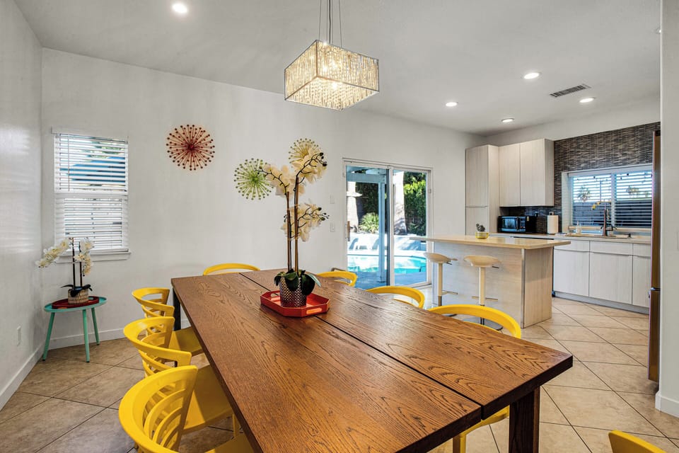 Dining area beside the open kitchen with direct pool access