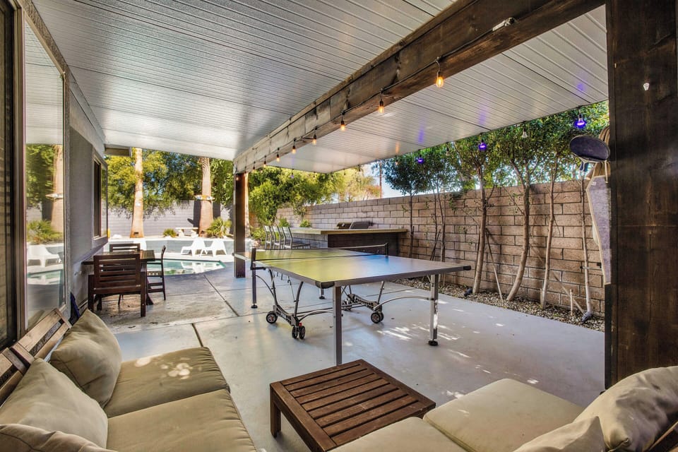 Shaded game patio with comfortable seating and easy pool access