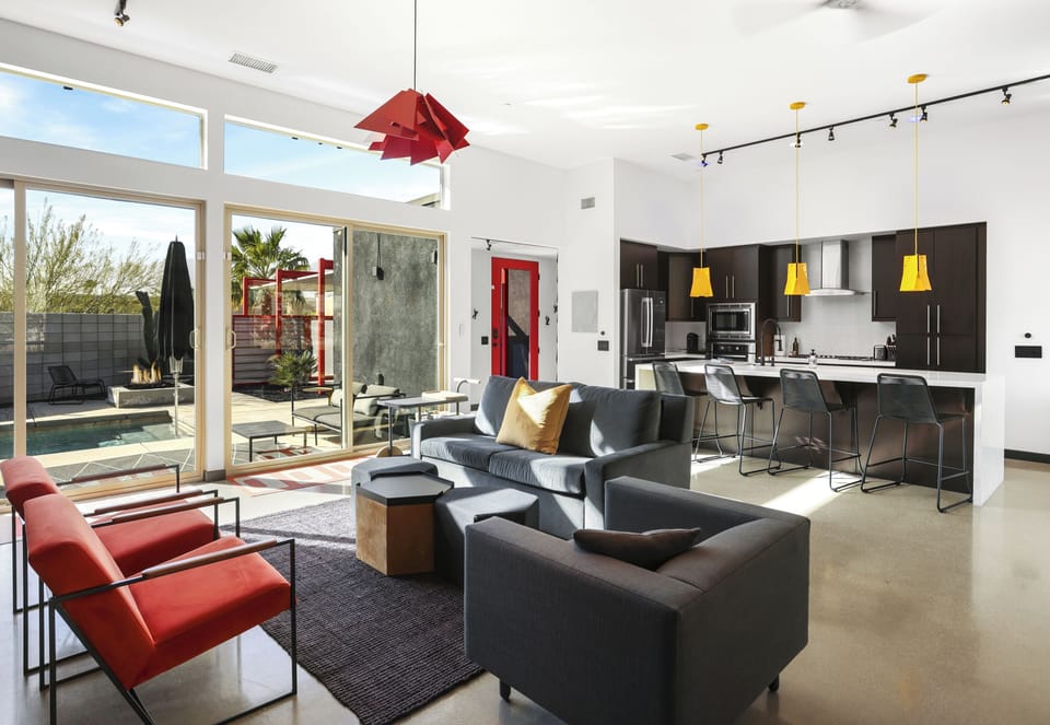 Open-concept living room and kitchen with direct patio access