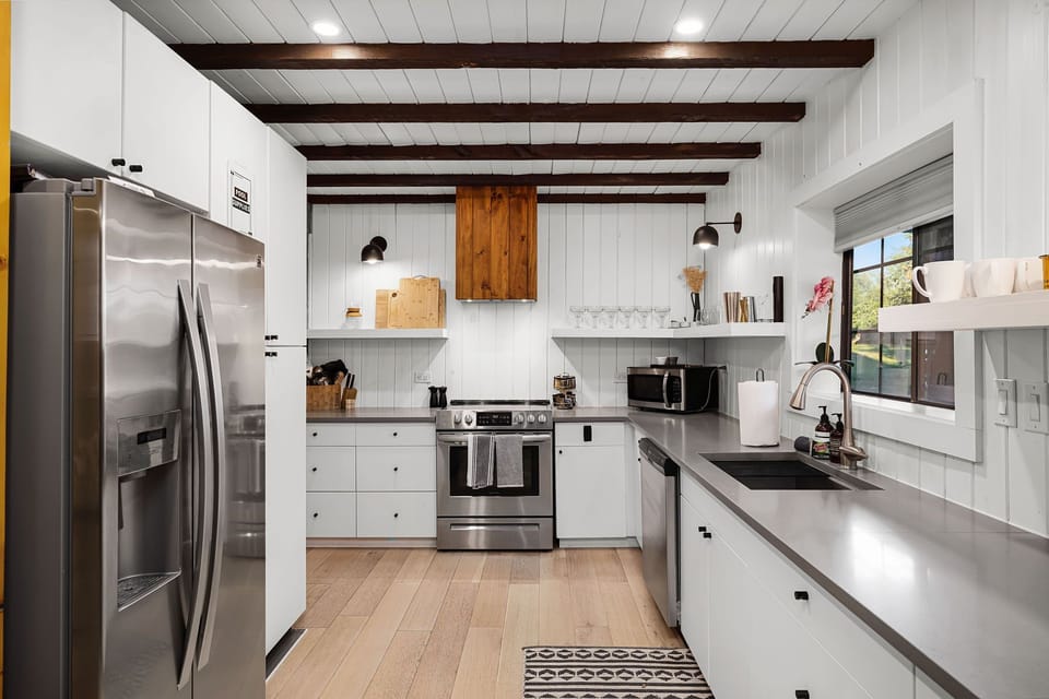 Whip up a farmhouse breakfast in this bright kitchen featuring sleek stainless steel appliances and custom wood accents. We’ve stocked all the essentials so you can cook a full meal before heading to Main Street.
