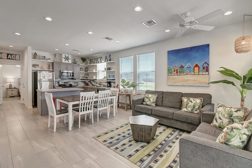 Your bright, open living space seamlessly blends kitchen and lounge areas with coastal charm and tropical touches throughout.