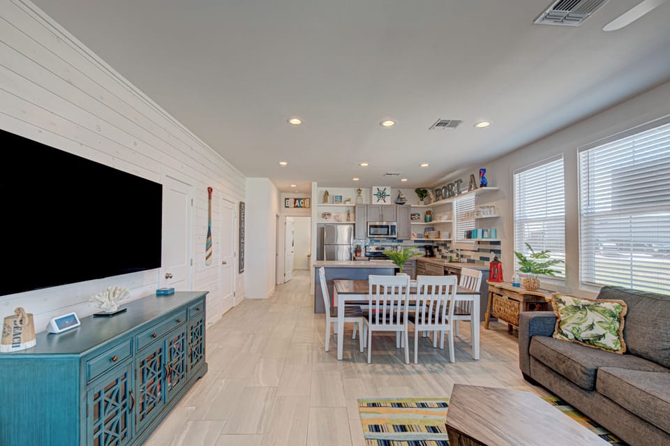 Relax in your open-concept living space where coastal charm meets modern comfort, complete with full kitchen and dining for memorable meals together.