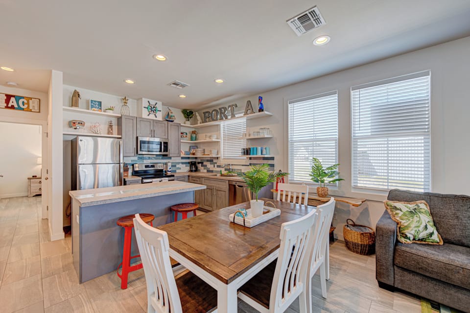 Gather around your spacious kitchen island while family meals simmer, then enjoy dining together at the rustic farmhouse table.