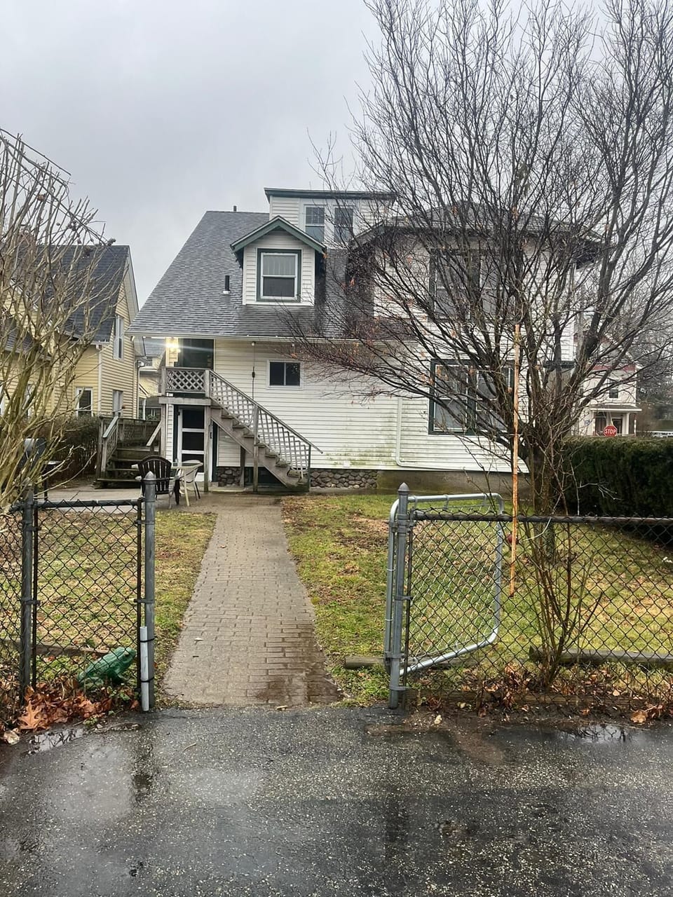 Side of the home showing stairs with second entrance to apartment
