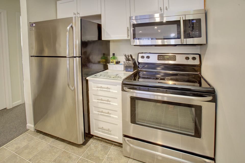 Large Fridge, Lots of appliances including: Toaster, microwave, oven, stove, kettle, coffee maker.